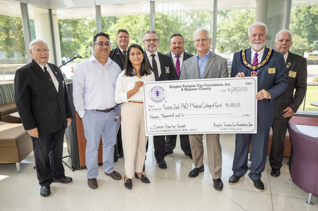 Group of nine hold giant check