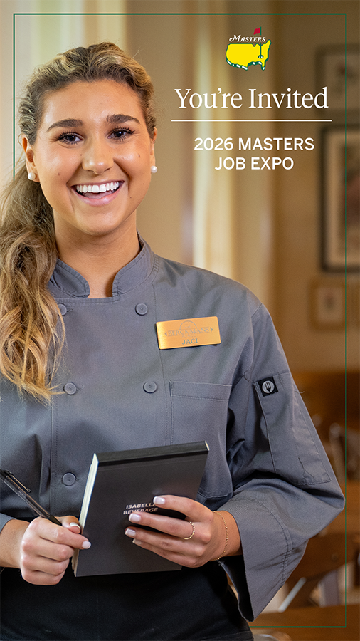 A female college student dressed as a waitress holds a notepad.