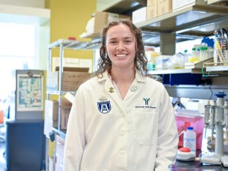 young woman in white lab coat