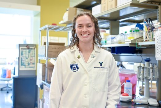 young woman in white lab coat