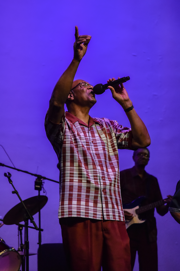 A man singing on stage.