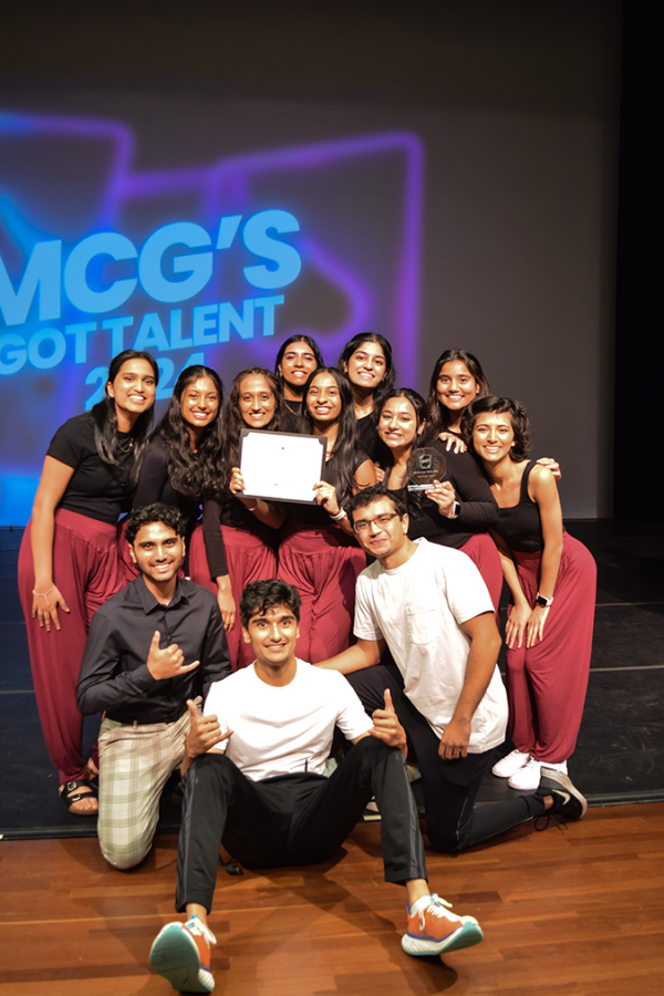 A group of college students celebrate placing in a talent show.