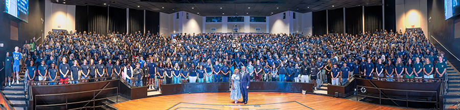 A group of over 1,000 people in a large performing arts theatre.