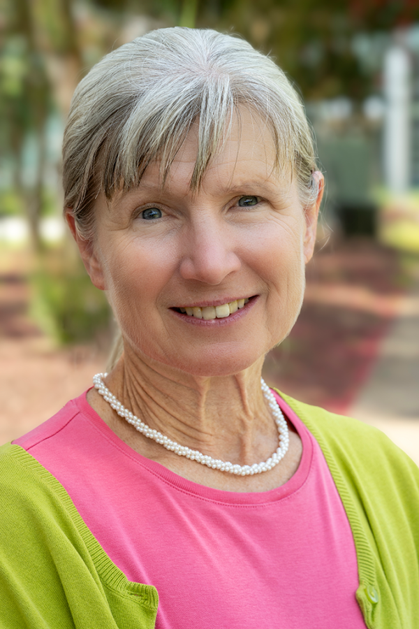 A close-up of a woman smiling at the camera.
