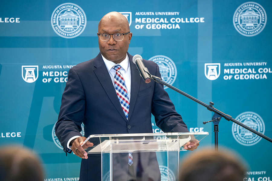 A man speaks at a podium during a special ceremony.