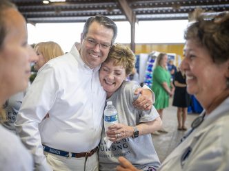 man hugs woman