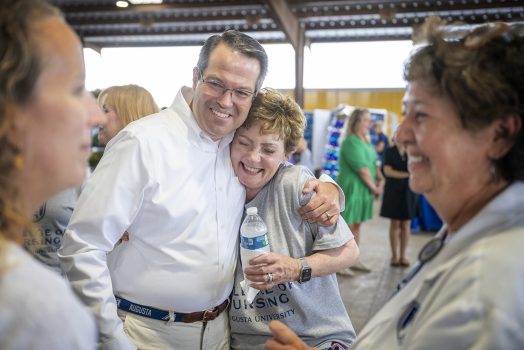 man hugs woman