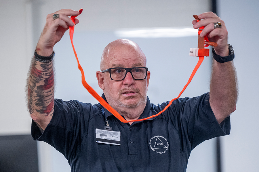 A man demonstrates how to properly use a Stop the Bleed kit.