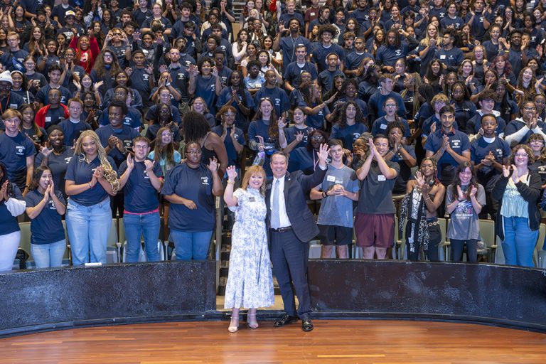 group of people holding a paw