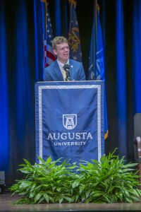 Man speaks at podium