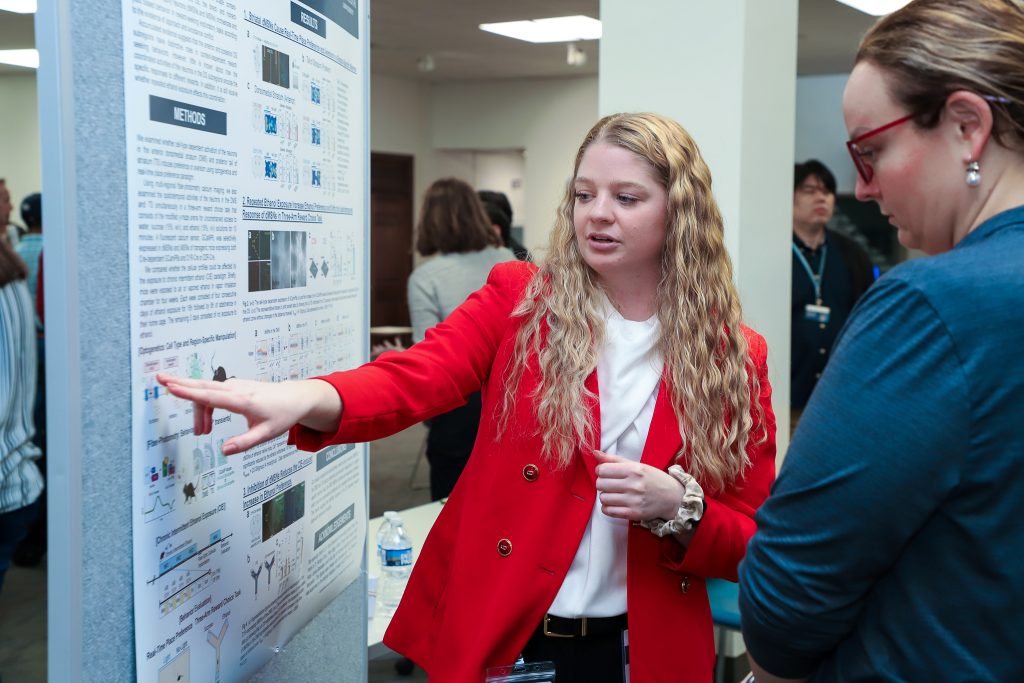 student presents research to professor