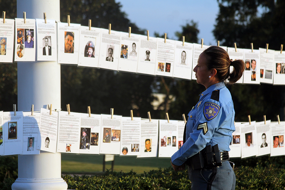Woman officer looks at photos hanging on a line