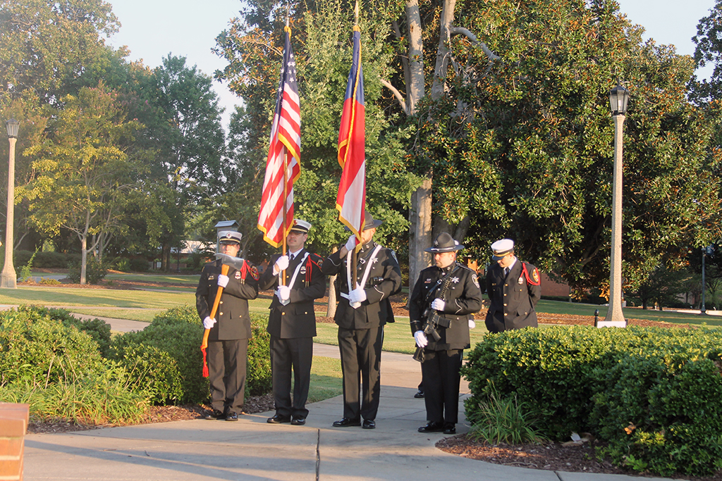 Men holding flags at attention
