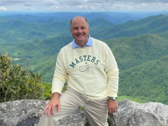 Man on a mountain smiling