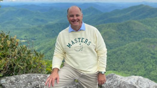Man on a mountain smiling