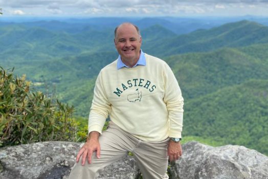 Man on a mountain smiling