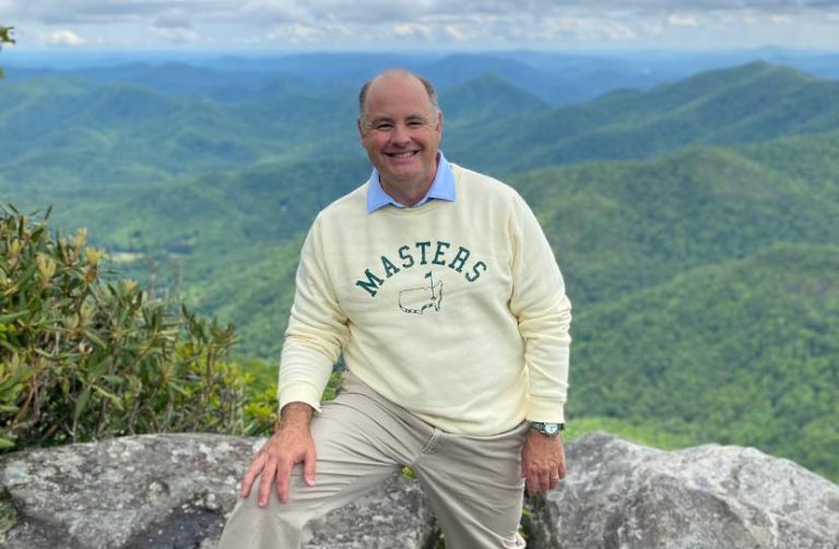 Man on a mountain smiling