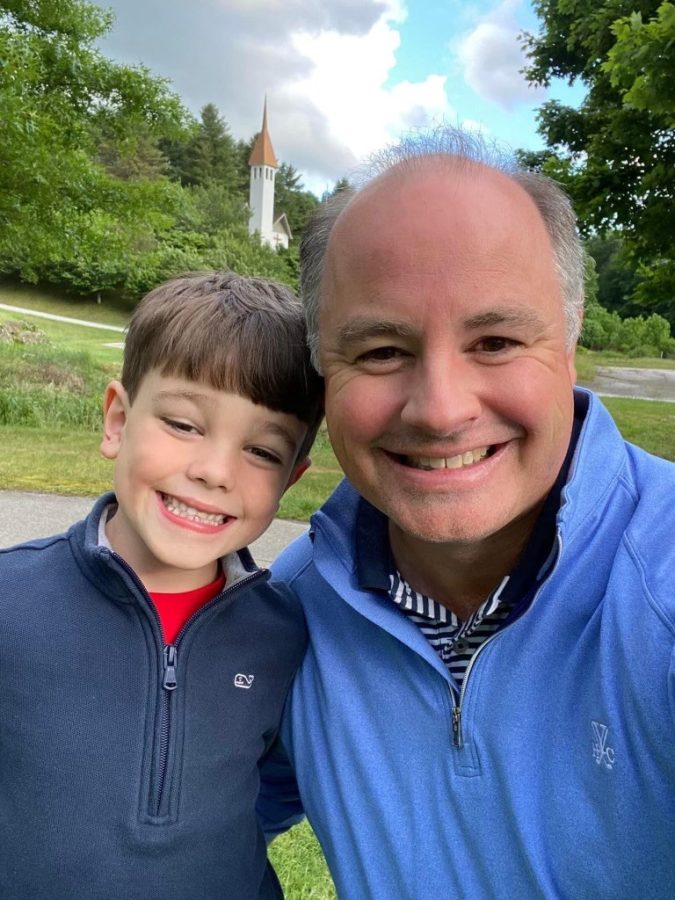 Man and son smiling while outside