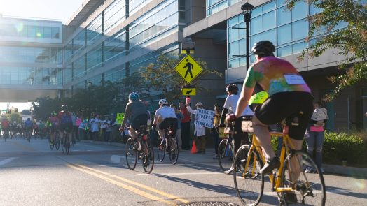 This photo shows men and women riding bicycles on a street during Paceday 2023.