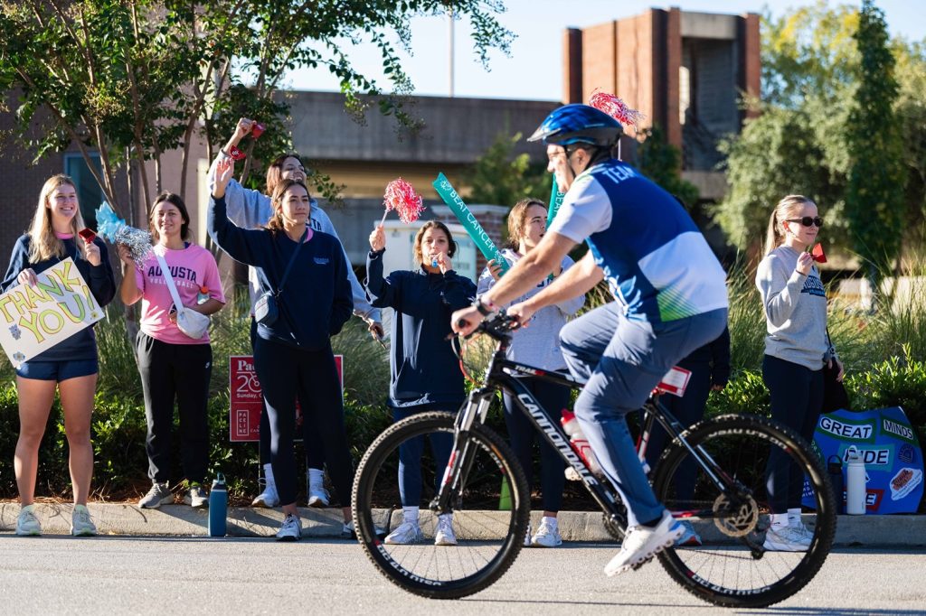 Dr. Russell Keen rides his bicycle on the street during PaceDay 2023.