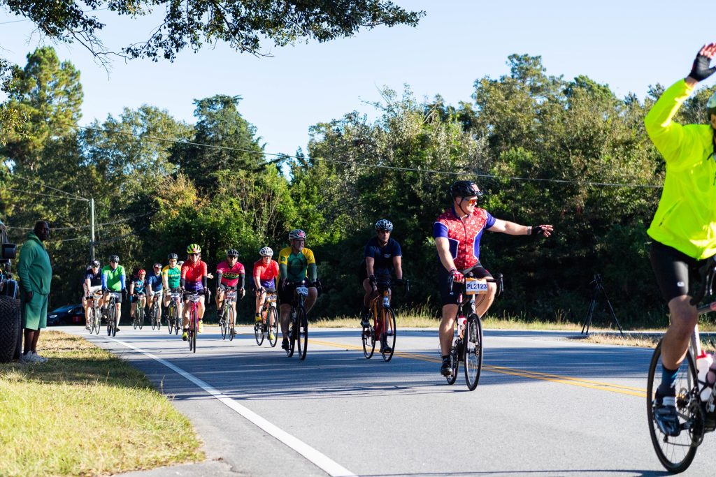 Men and women ride bicycles on a street during Paceday 2023.
