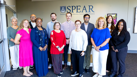 A group of people who work in simulation education pose for a photo.