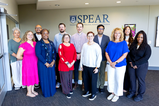 A group of people who work in simulation education pose for a photo.