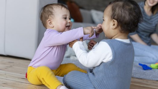 Babies playing with each other