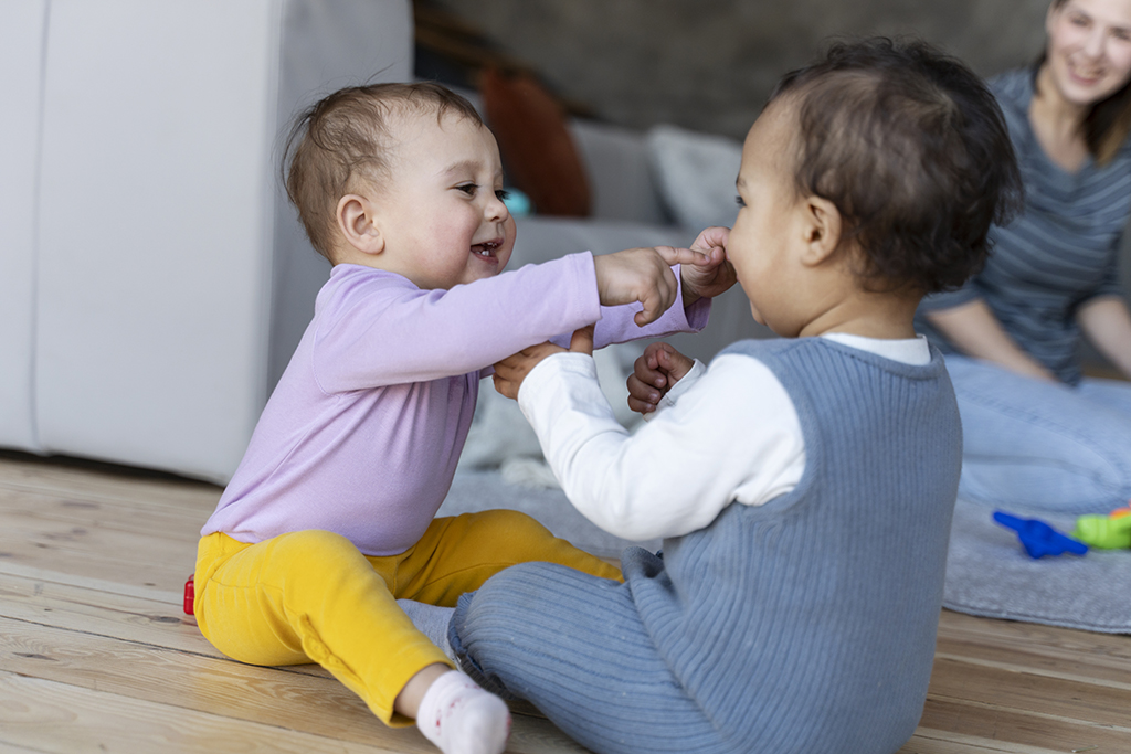 Babies playing with each other