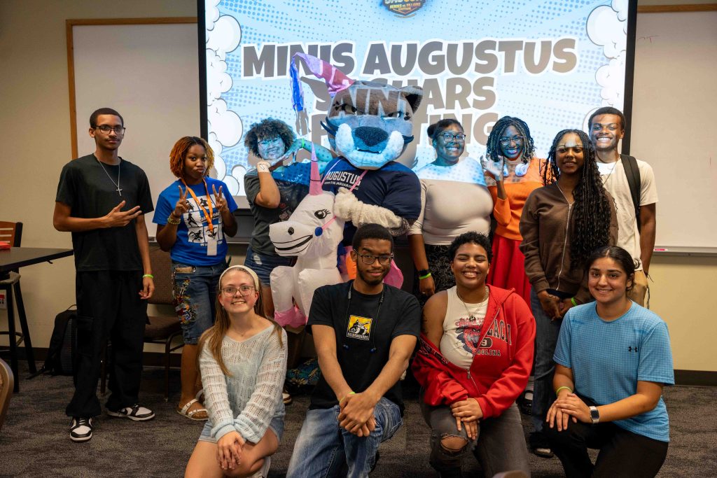 A group of college students gather in a classroom for an extracurricular event.