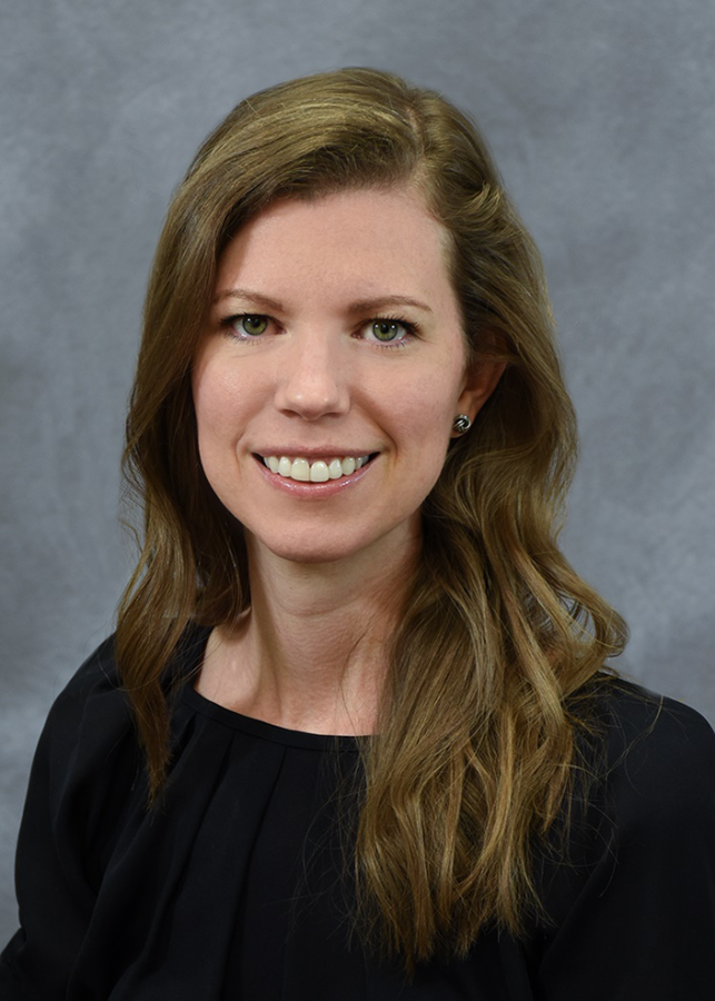 A woman smiles in a professional headshot.