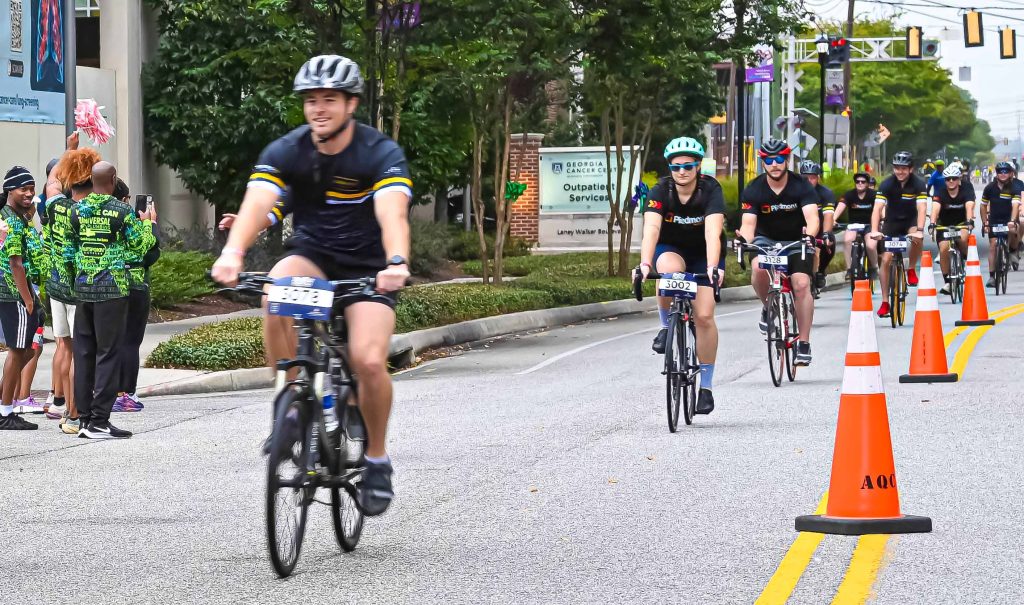 In this photo, you see people riding bicycles in the street during the PaceDay 2025 event to raise money for the Georgia Cancer Center.