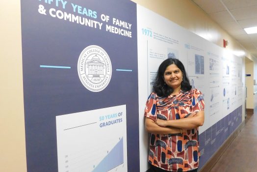 Woman standing by a sign