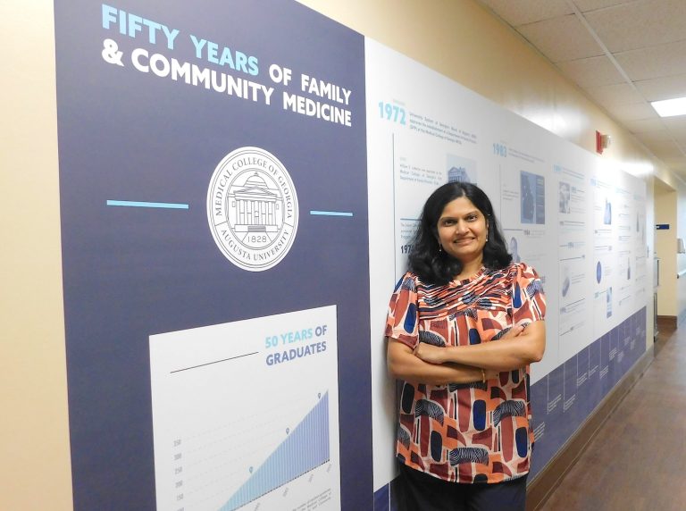 Woman standing by a sign