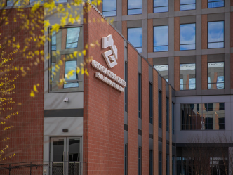 The outside of a state-of-the-art building. There is a logo that reads "Georgia Cyber Innovation and Training Center" on one side.