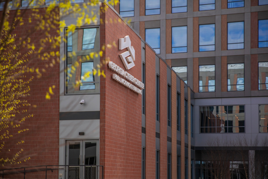 The outside of a state-of-the-art building. There is a logo that reads "Georgia Cyber Innovation and Training Center" on one side.