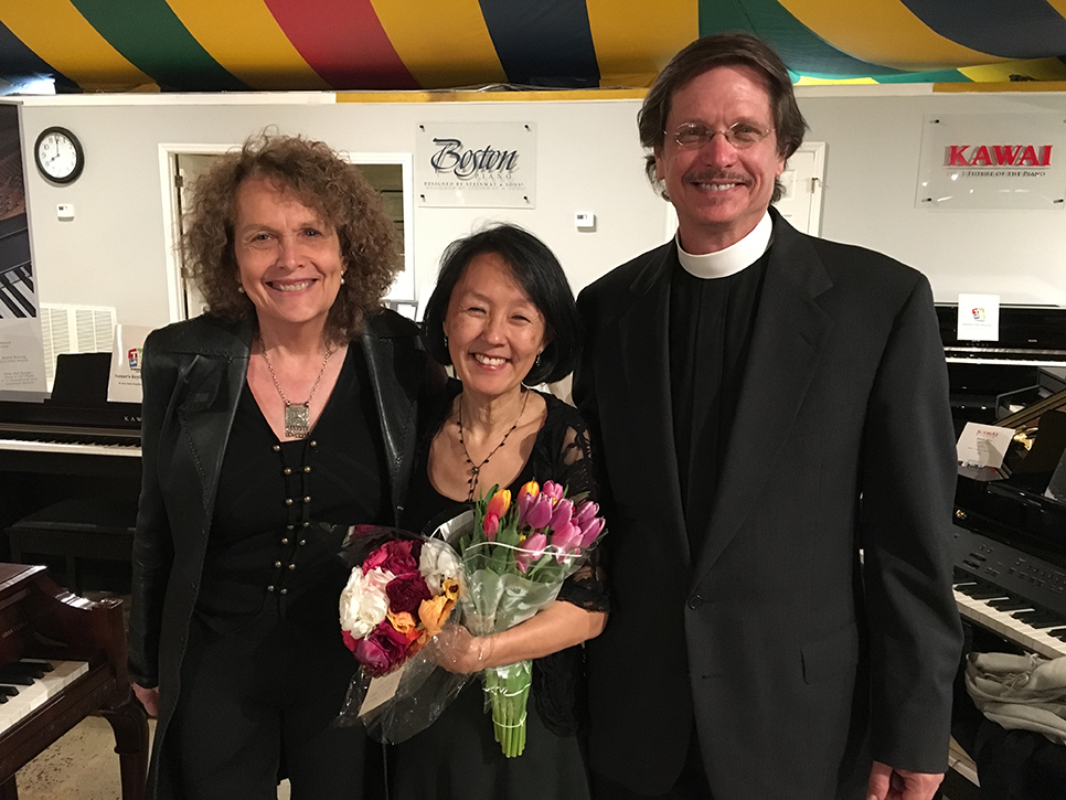 Two women and a man smiling