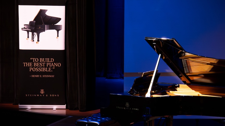 Piano with a sign on stage