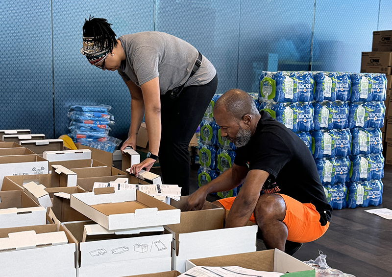 A man and a woman work to stock supplies needed following a natural disaster.