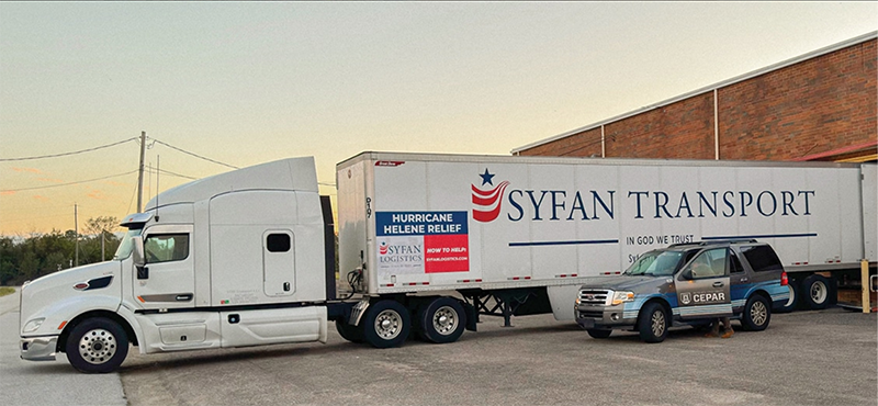 A tractor trailer getting ready to leave a warehouse.