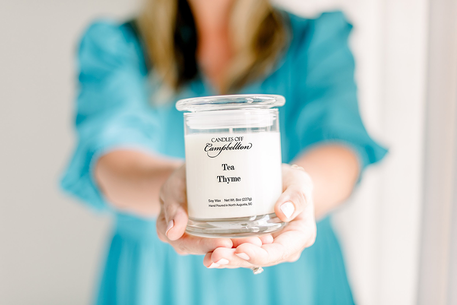 A woman holds up a candle.