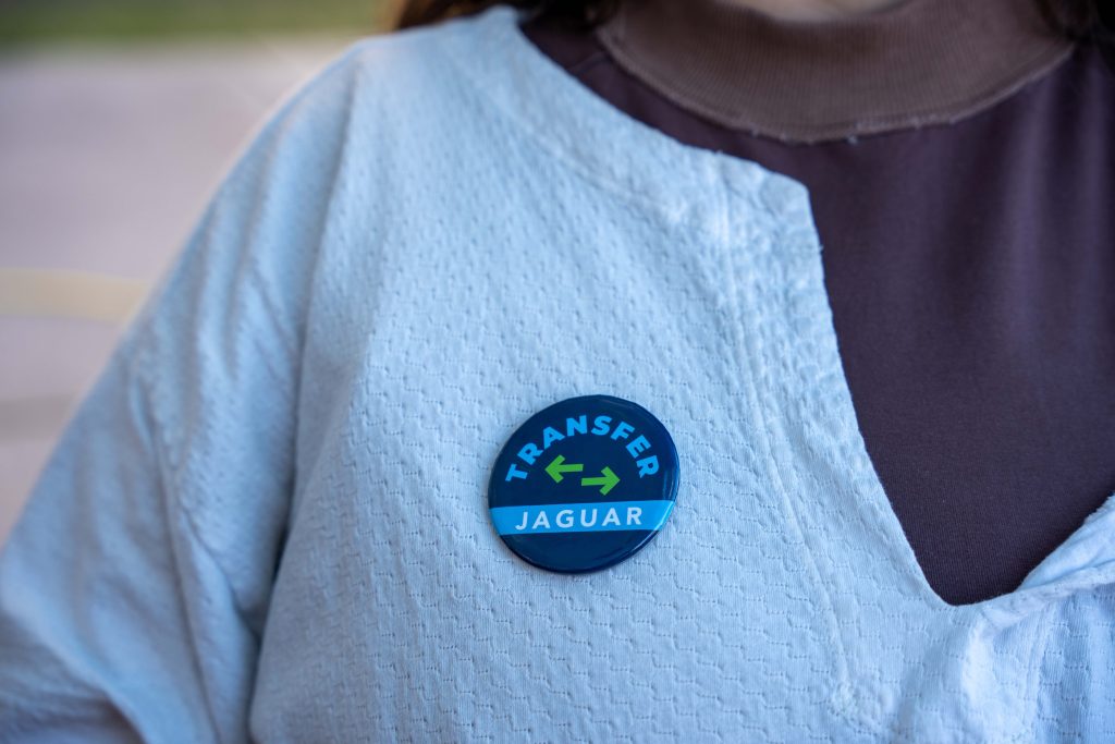 A close-up photo of a button that reads "Transfer Jaguar."