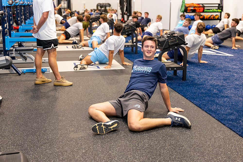 A group of college student-athletes work out in a brand new performance center.
