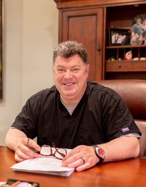 Dentist sitting at a desk.
