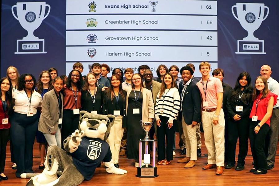 A large group of high school students celebrate winning a competition held at a local college.