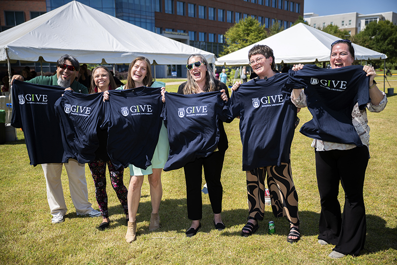 Happy people holding t-shirts
