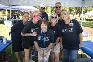 People wearing IGIVE t-shirts smiling