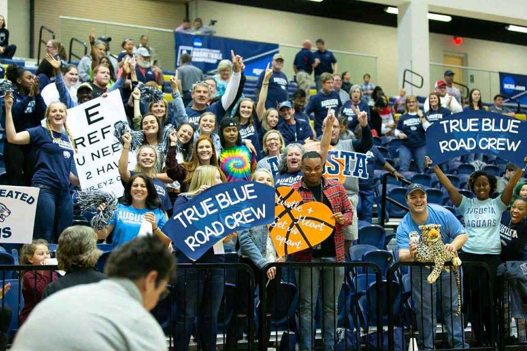 Men and women cheering on a basketball team