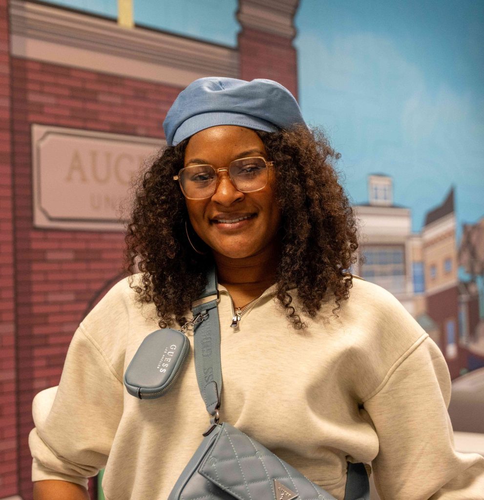 A high school-aged girl takes a tour of a college campus.