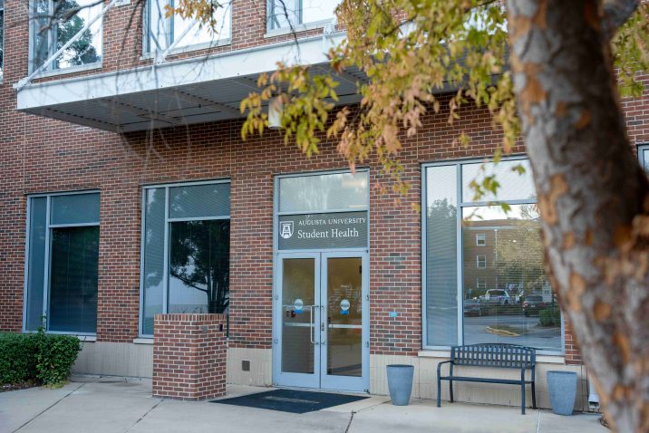 Brick building with a tree on the right side.